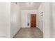 Inviting foyer featuring neutral tile flooring, coat closet and a wooden front door at 510 W Amoroso Dr, Gilbert, AZ 85233