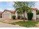 Cozy home with a two-car garage and front yard with shade tree and desert landscaping at 510 W Amoroso Dr, Gilbert, AZ 85233