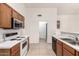 Well-lit kitchen features standard appliances, white countertops, and warm wood cabinetry at 510 W Amoroso Dr, Gilbert, AZ 85233
