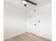 Bright bedroom featuring a ceiling fan, wood-look flooring, and a single door at 524 S Pioneer --, Mesa, AZ 85204