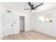 Bright bedroom featuring a ceiling fan, wood-look flooring, and closet at 524 S Pioneer --, Mesa, AZ 85204