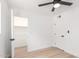 Bright bedroom featuring a ceiling fan, wood-look flooring, and a closet at 524 S Pioneer --, Mesa, AZ 85204