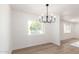 Dining room with stylish light fixture, and a large window at 524 S Pioneer --, Mesa, AZ 85204
