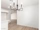 Open-concept dining area with hardwood flooring and a modern black chandelier at 524 S Pioneer --, Mesa, AZ 85204