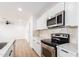 Updated kitchen with stainless steel appliances, white cabinets, and quartz countertops at 524 S Pioneer --, Mesa, AZ 85204