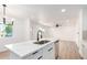 Kitchen with island and stainless steel appliances, with a view to the living area at 524 S Pioneer --, Mesa, AZ 85204
