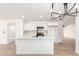 Bright, open kitchen featuring stainless steel appliances, white cabinetry, and a kitchen island at 524 S Pioneer --, Mesa, AZ 85204