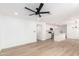 Open-concept living area with hardwood flooring and a combined kitchen and dining area at 524 S Pioneer --, Mesa, AZ 85204