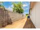 Side yard enclosed by a block wall, features dirt and offers space for potential landscaping or storage at 524 S Pioneer --, Mesa, AZ 85204