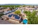 Aerial view of home with solar panels, fenced backyard with pool, and neighborhood at 5401 S Dove Holw, Buckeye, AZ 85326