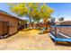 Backyard with grassy area, mature tree, playground with slide, and a trampoline at 5401 S Dove Holw, Buckeye, AZ 85326