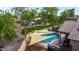 Landscaped backyard features a private pool, shaded seating, and beautiful landscaping at 5401 S Dove Holw, Buckeye, AZ 85326