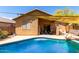 Backyard view of covered patio with ample seating, sliding glass doors, and exterior window at 5401 S Dove Holw, Buckeye, AZ 85326