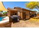 Backyard featuring a BBQ grill, outdoor shower, privacy walls, and desert landscaping at 5401 S Dove Holw, Buckeye, AZ 85326