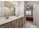Bright bathroom features dual sinks, neutral tones, and bedroom access at 5401 S Dove Holw, Buckeye, AZ 85326