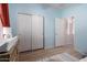 Bedroom featuring wood-look floors, neutral paint, closet, and hallway access at 5401 S Dove Holw, Buckeye, AZ 85326