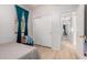 Bedroom with turquoise curtains, closet, and access to other rooms at 5401 S Dove Holw, Buckeye, AZ 85326