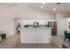 Bright, spacious kitchen with white cabinetry, stainless steel appliances, and a breakfast bar at 5401 S Dove Holw, Buckeye, AZ 85326