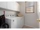 Well-lit laundry room with washer, dryer, and ample storage at 5401 S Dove Holw, Buckeye, AZ 85326