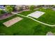 Aerial view of neighborhood park with basketball court, swing set, and walking path at 5401 S Dove Holw, Buckeye, AZ 85326