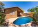 Inviting backyard pool with a Baja shelf, covered patio, and ample space for outdoor entertaining at 5401 S Dove Holw, Buckeye, AZ 85326