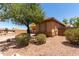 Side view of a tan single-story home with desert landscaping and privacy wall at 5401 S Dove Holw, Buckeye, AZ 85326