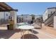 Outdoor common area with barbecue, dining tables, and building access with stairs under a partly covered patio at 6236 N 16Th St # 1, Phoenix, AZ 85016