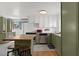 Charming kitchen with olive green cabinets, a kitchen island, and modern appliances at 6236 N 16Th St # 1, Phoenix, AZ 85016