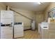 Functional laundry room equipped with stacked washer/dryer, standard washing machine, and water heater at 6236 N 16Th St # 1, Phoenix, AZ 85016