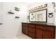 Bathroom with a dark vanity, stylish shelving and decorative plants at 6426 W Lamar Rd, Glendale, AZ 85301