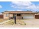 Charming single-story home with a well-maintained front yard, two car garage, and a covered porch at 6426 W Lamar Rd, Glendale, AZ 85301