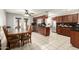 Open kitchen with a dining area, stainless steel appliances, and dark wood cabinets at 6426 W Lamar Rd, Glendale, AZ 85301