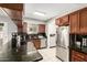 Kitchen featuring stainless steel appliances, black granite countertops, and wood cabinetry at 6426 W Lamar Rd, Glendale, AZ 85301