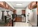 Modern kitchen with stainless steel appliances, a dishwasher, and access to the backyard at 6426 W Lamar Rd, Glendale, AZ 85301