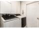 Well-equipped laundry room with modern washer and dryer, plus upper cabinet storage at 6426 W Lamar Rd, Glendale, AZ 85301