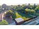 Aerial perspective of the backyard highlighting metal sheds, grass area, trees, and perimeter fencing at 645 S Esquire Way, Mesa, AZ 85202