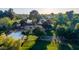 Lush aerial view of home, sprawling green lawn, and mature trees at 645 S Esquire Way, Mesa, AZ 85202
