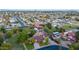 Expansive aerial view showcasing the neighborhood's mature trees, swimming pools, and a mix of home styles at 645 S Esquire Way, Mesa, AZ 85202