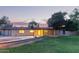 Charming backyard with mature trees, a covered patio, and a lush green lawn at 645 S Esquire Way, Mesa, AZ 85202