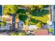 Aerial shot of a large backyard with green grass, mature trees, a garden area, and privacy fencing at 645 S Esquire Way, Mesa, AZ 85202