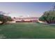 Expansive backyard with lush green grass, mature trees, and a serene atmosphere at 645 S Esquire Way, Mesa, AZ 85202