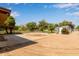 Expansive backyard featuring a horse training pen, metal shed, mature trees, and plenty of space at 645 S Esquire Way, Mesa, AZ 85202