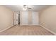 Neutral bedroom features plush carpeting, ceiling fan, and ample closet space with multiple doors at 645 S Esquire Way, Mesa, AZ 85202
