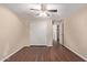Bedroom with hardwood flooring, neutral walls, ceiling fan, closet and access to another room at 645 S Esquire Way, Mesa, AZ 85202