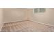 The carpeted bedroom has a neutral color scheme and a window for natural light at 645 S Esquire Way, Mesa, AZ 85202