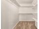 Bright and airy walk-in closet with shelving and hanging rods, offering ample storage at 645 S Esquire Way, Mesa, AZ 85202
