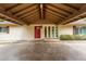 Welcoming front entrance with a covered carport, a bright red door, and white brick exterior at 645 S Esquire Way, Mesa, AZ 85202