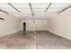 A spacious two car garage with concrete flooring provides ample space for parking and storage at 645 S Esquire Way, Mesa, AZ 85202