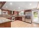 Modern kitchen with stainless steel appliances, granite countertops, tile backsplash, and ample cabinet space at 645 S Esquire Way, Mesa, AZ 85202