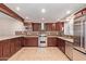 Beautiful kitchen boasting granite countertops, stainless steel appliances, and mosaic backsplash at 645 S Esquire Way, Mesa, AZ 85202
